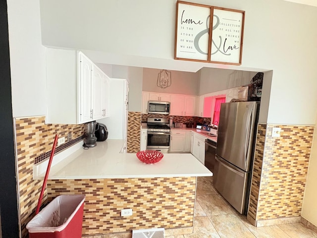 16117 Wabash Ave, South Holland, IL 60473 - kitchen with stainless steel appliances, tasteful backsplash, a peninsula, light countertops, and white cabinets