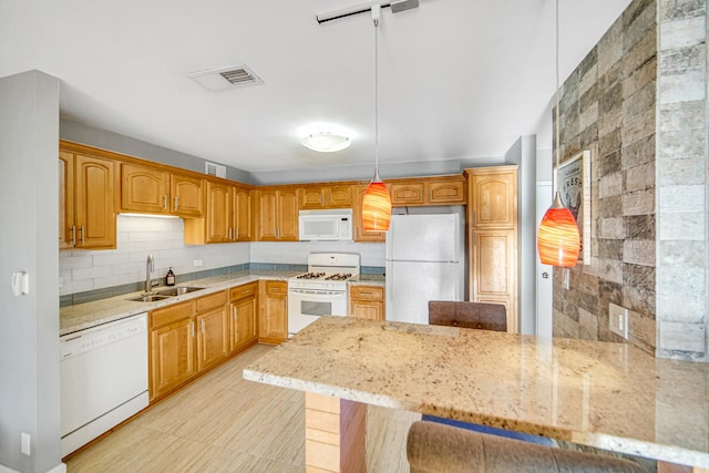 2201 S Grace St Unit 608, Lombard, IL 60148 - kitchen featuring light stone counters, a sink, white appliances, a peninsula, and decorative backsplash