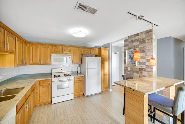 2201 S Grace St Unit 608, Lombard, IL 60148 - kitchen with visible vents, white appliances, a kitchen bar, tasteful backsplash, and light stone counters