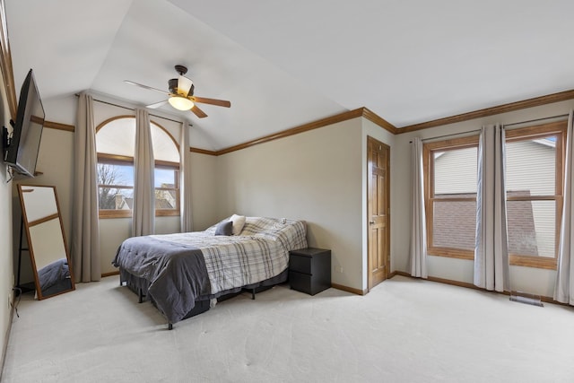 bedroom featuring visible vents, baseboards, ornamental molding, vaulted ceiling, and light carpet