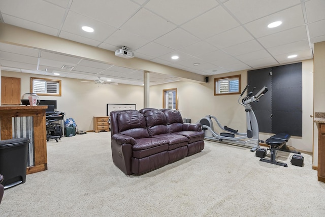 carpeted living area with recessed lighting and a paneled ceiling