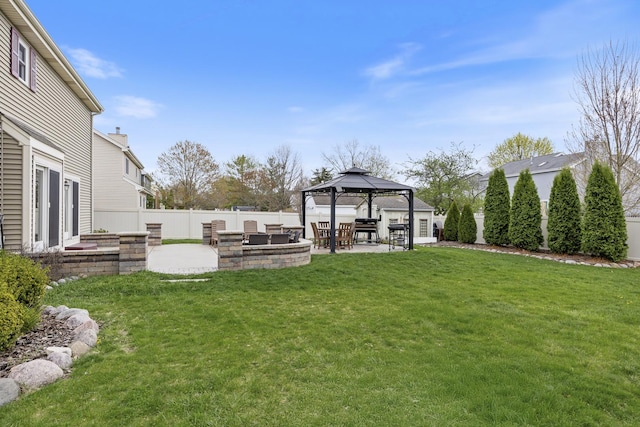 view of yard with a fire pit, a gazebo, a patio area, and a fenced backyard