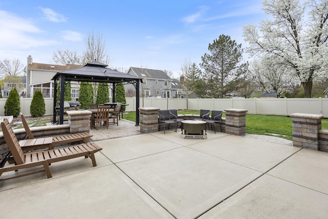 view of patio / terrace featuring a fire pit, a gazebo, outdoor dining space, and a fenced backyard