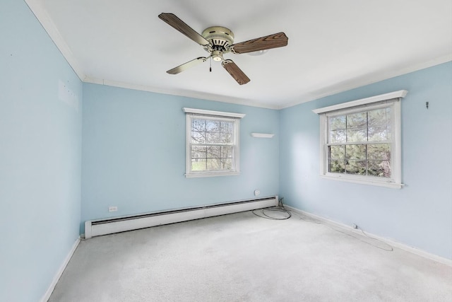 spare room with a baseboard heating unit, carpet, baseboards, and a wealth of natural light