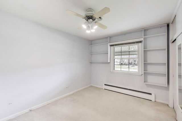 carpeted empty room featuring a baseboard radiator, baseboards, and a ceiling fan