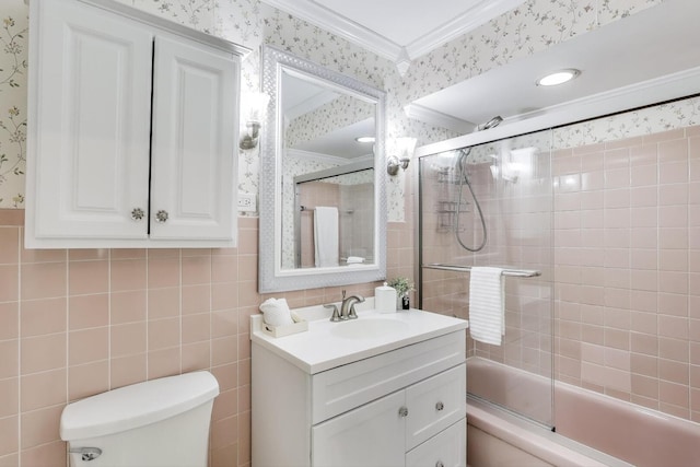 full bath featuring shower / bath combination with glass door, toilet, wallpapered walls, crown molding, and vanity
