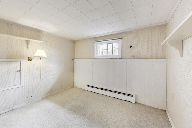 basement with a baseboard heating unit and carpet