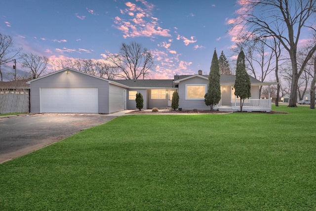 ranch-style house featuring fence and a front lawn