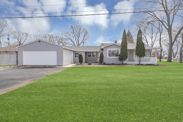 ranch-style home with an attached garage, driveway, and a front yard