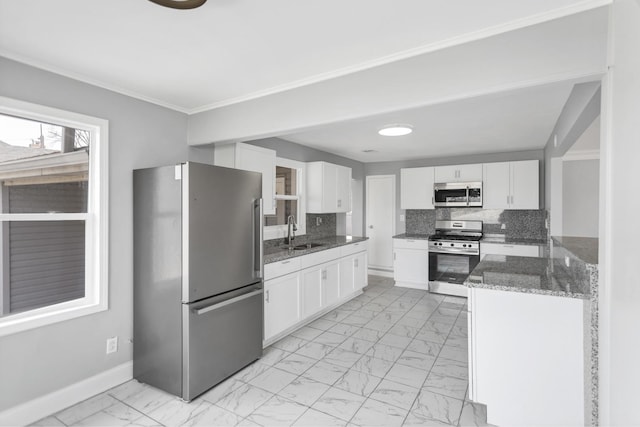 kitchen with marble finish floor, decorative backsplash, appliances with stainless steel finishes, and white cabinetry