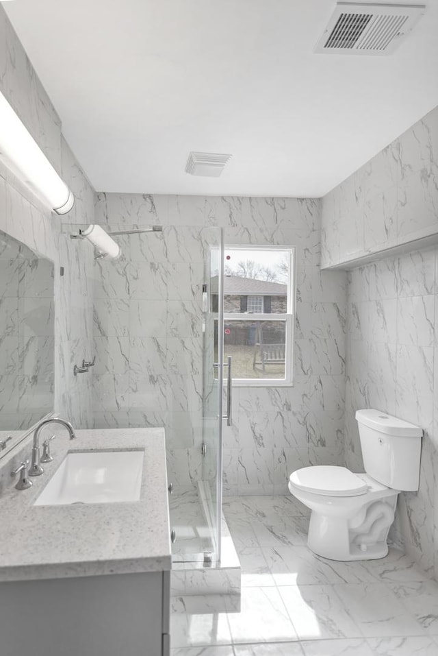 bathroom with marble finish floor, visible vents, toilet, vanity, and a marble finish shower