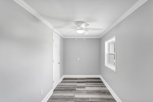 unfurnished room featuring wood finished floors, a ceiling fan, baseboards, and ornamental molding