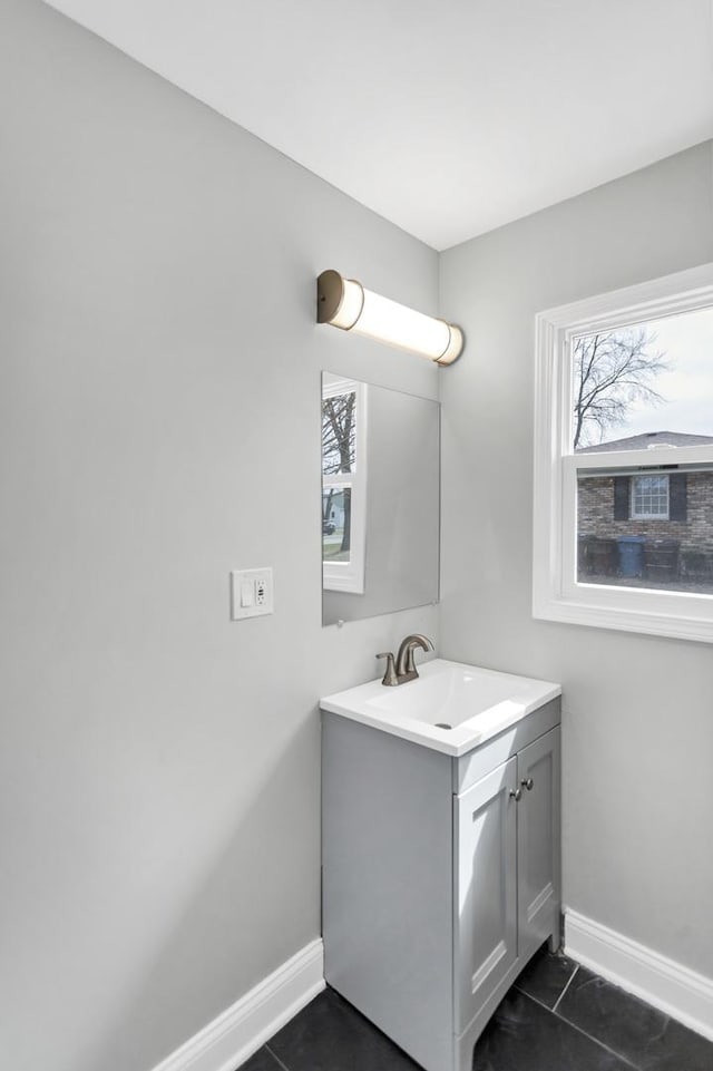 bathroom with tile patterned flooring, baseboards, and vanity