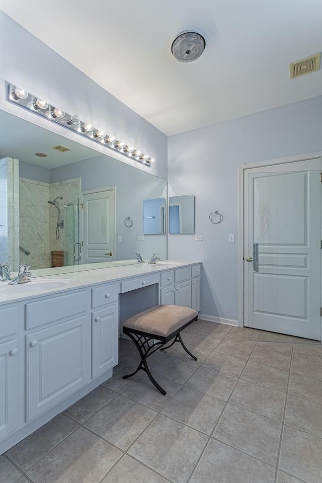 bathroom featuring a shower stall, visible vents, tile patterned floors, and a sink