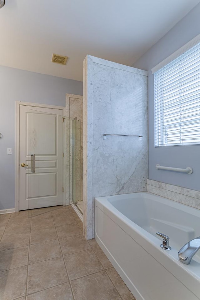 full bathroom featuring a shower stall, a bath, tile patterned floors, and visible vents