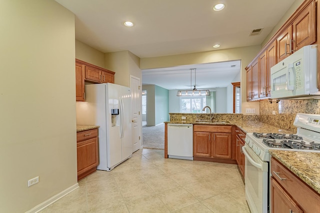 kitchen featuring recessed lighting, backsplash, visible vents, a sink, and white appliances