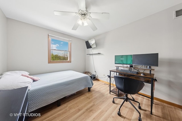 bedroom featuring ceiling fan, visible vents, baseboards, and light wood-type flooring