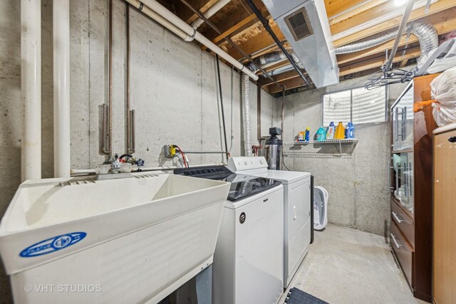 laundry room featuring separate washer and dryer, laundry area, and a sink