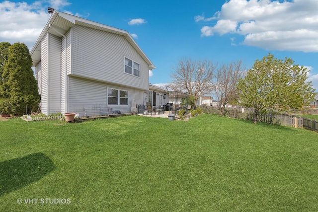 back of property featuring a yard, a patio, and fence