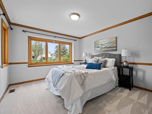 bedroom featuring light colored carpet, baseboards, and crown molding