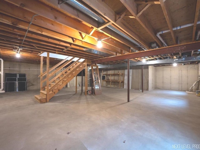 unfinished basement featuring stairway