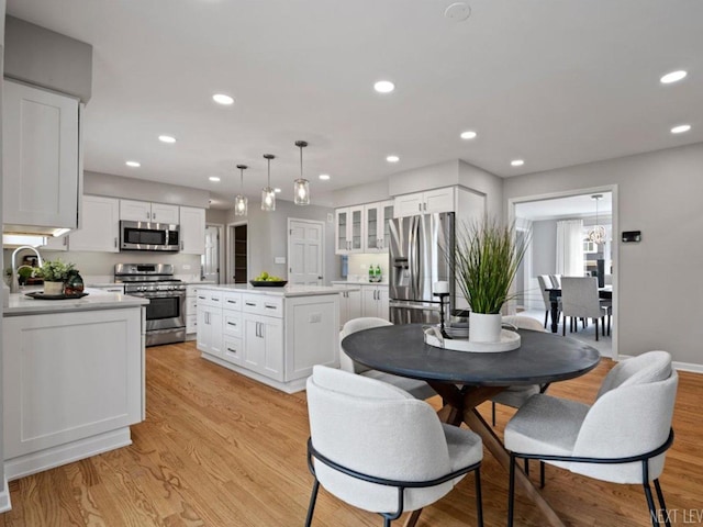 kitchen with recessed lighting, light countertops, white cabinetry, and appliances with stainless steel finishes