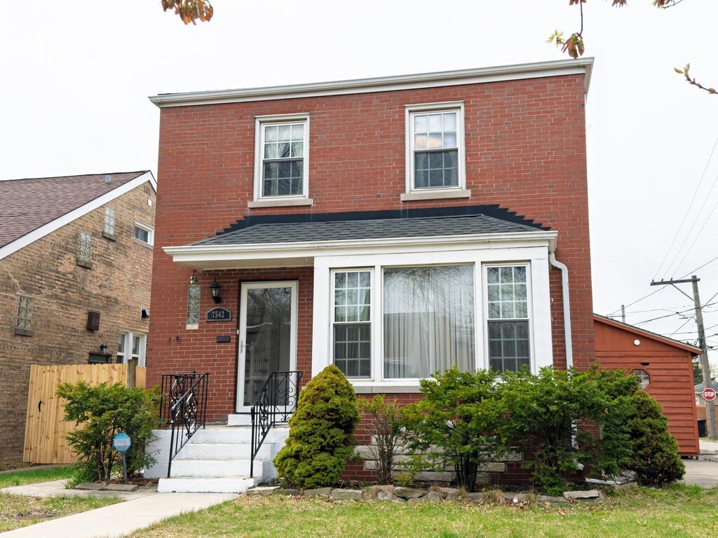 7542 N Rockwell St, Chicago, IL 60645 - view of front facade with brick siding and fence