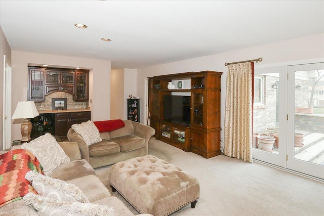 living room featuring light carpet and recessed lighting
