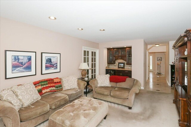 living area with light carpet and recessed lighting