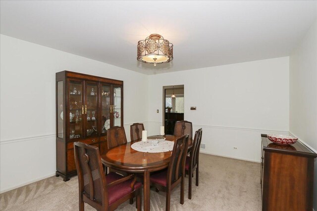 dining space with light colored carpet