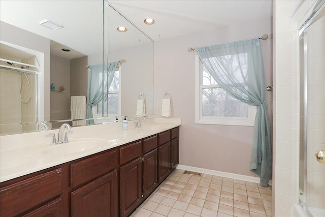 full bath with a tile shower, tile patterned floors, a sink, and visible vents
