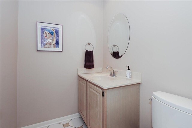 half bath featuring toilet and vanity