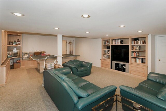 carpeted living room with recessed lighting and built in shelves