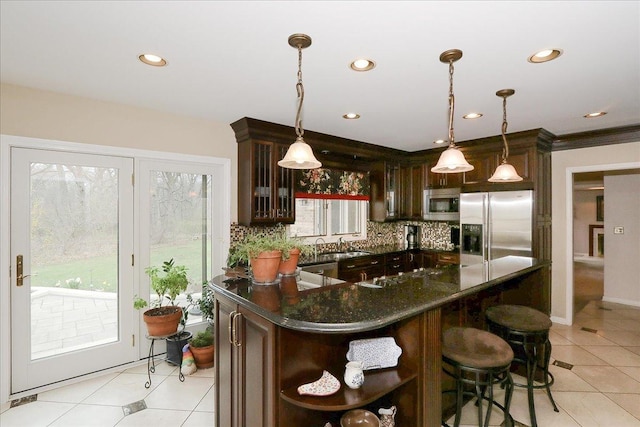 kitchen with open shelves, a wealth of natural light, appliances with stainless steel finishes, and dark brown cabinetry