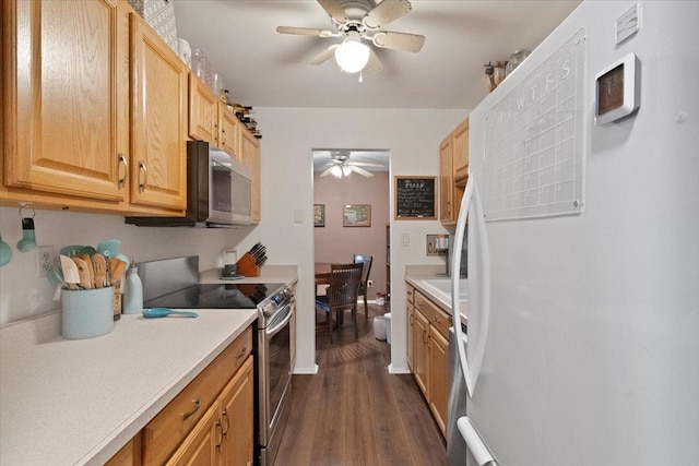 kitchen featuring light countertops, appliances with stainless steel finishes, dark wood-style flooring, and ceiling fan
