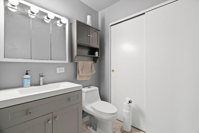 bathroom featuring toilet and vanity
