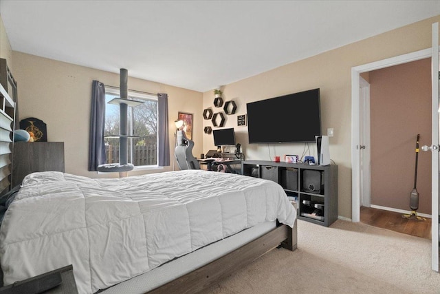 bedroom with baseboards and carpet