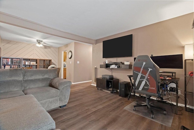living room featuring baseboards, ceiling fan, and wood finished floors