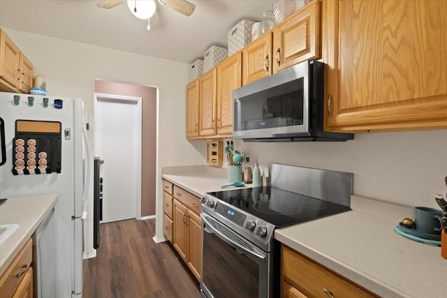 kitchen featuring light countertops, appliances with stainless steel finishes, dark wood-style flooring, and a ceiling fan
