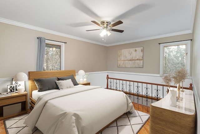 bedroom with ceiling fan, light wood finished floors, and ornamental molding