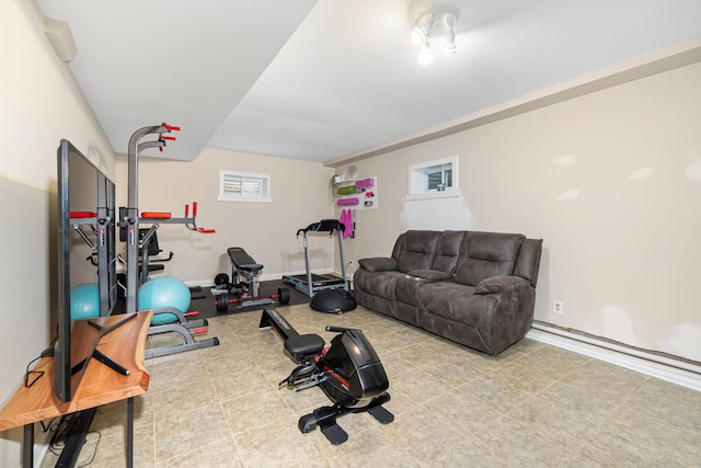 exercise area with tile patterned floors and baseboards