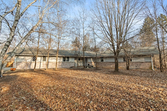 single story home featuring brick siding