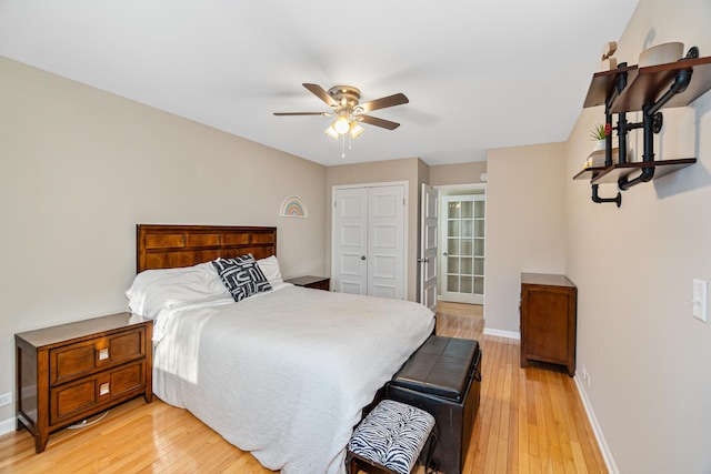 bedroom with ceiling fan, baseboards, light wood-style floors, and a closet