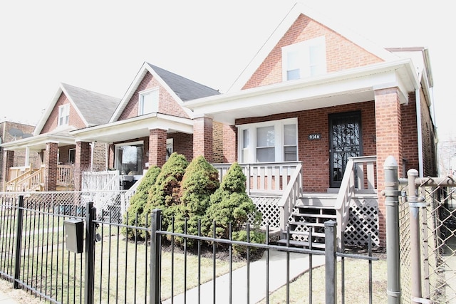 bungalow featuring brick siding, fence private yard, stairs, and covered porch