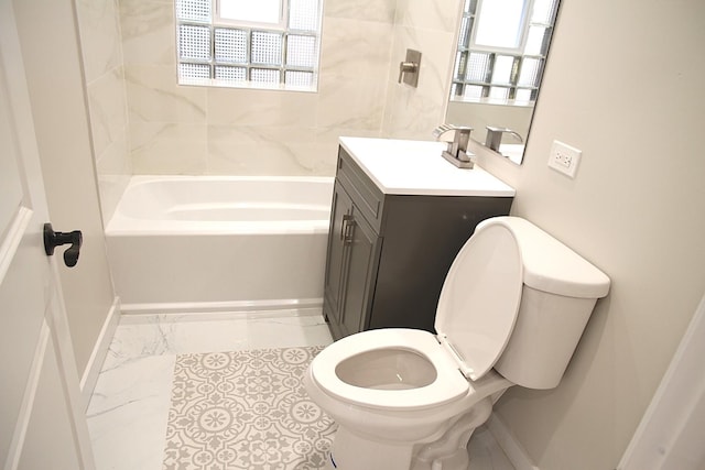 bathroom featuring marble finish floor, toilet, baseboards, and plenty of natural light
