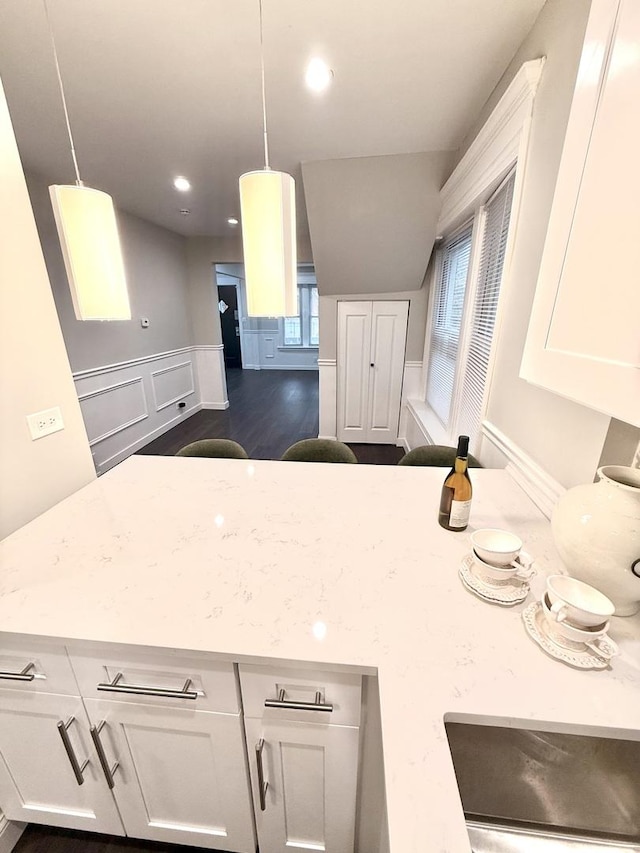 kitchen featuring white cabinets and lofted ceiling