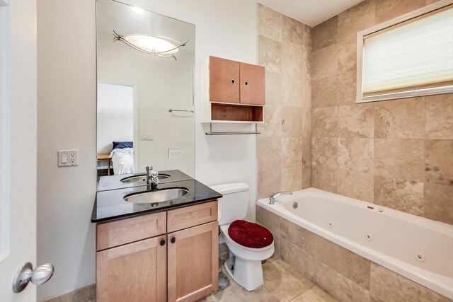 full bath featuring vanity, toilet, a tub with jets, tile patterned floors, and ensuite bath