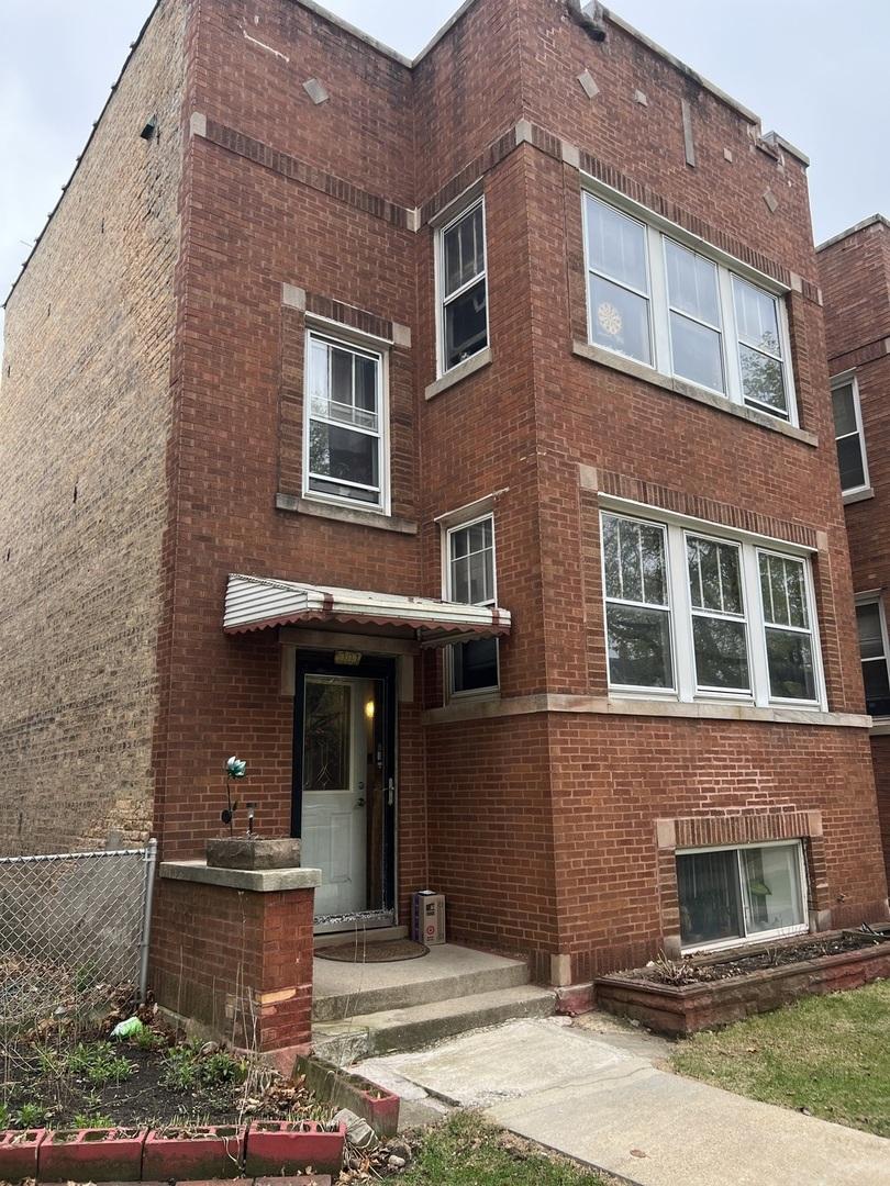 5107 W Strong St, Chicago, IL 60630 - exterior space with fence and brick siding