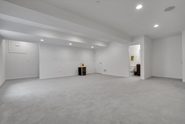 finished basement featuring recessed lighting, light carpet, and baseboards