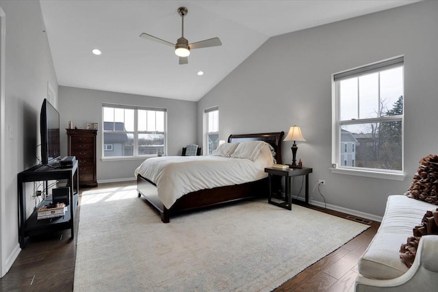 bedroom featuring baseboards, wood finished floors, and vaulted ceiling